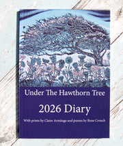 Diary titled 'Under The Hawthorn Tree 2026 Diary' with nature-themed cover on a wooden surface