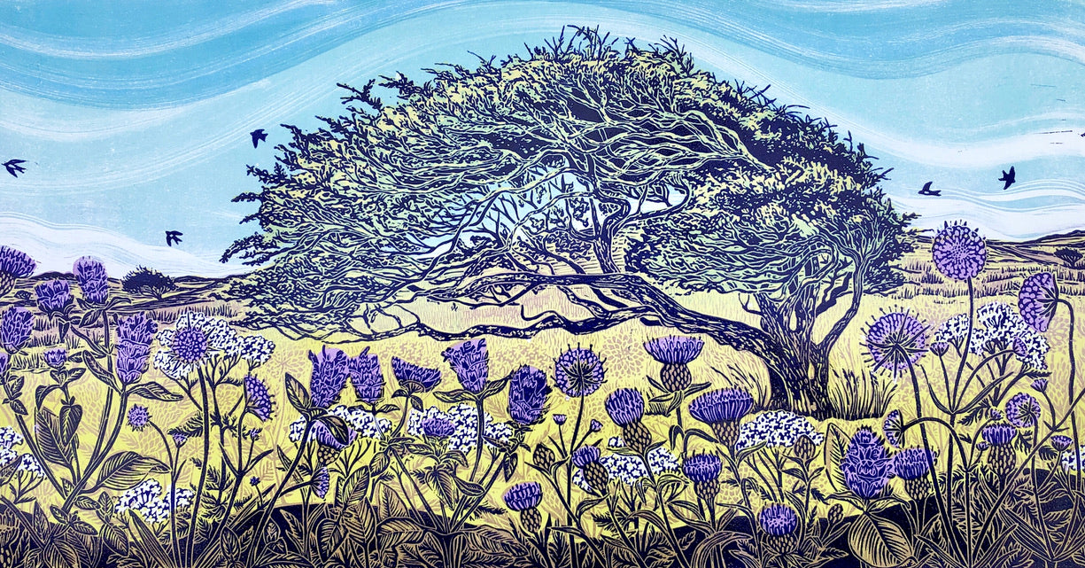 lino print of a hawthorn tree with wild flowers and blue sky.